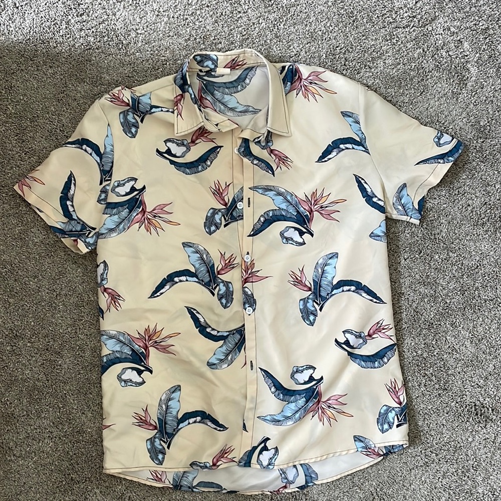 Beige button down shirt with bird of paradise flower